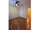 Spacious bedroom featuring wood-look floors and a double door closet at 6430 S Goldenrod Rd # 15B, Orlando, FL 32822