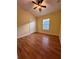 Bright bedroom with wood-look floors and ceiling fan at 6430 S Goldenrod Rd # 15B, Orlando, FL 32822
