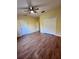 Bright bedroom with wood flooring, ceiling fan and double doors to closet at 6430 S Goldenrod Rd # 15B, Orlando, FL 32822