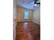 Well-lit bedroom with wood-look floors and a window with blinds at 6430 S Goldenrod Rd # 15B, Orlando, FL 32822