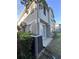 Townhome side view showing AC unit and patio at 6430 S Goldenrod Rd # 15B, Orlando, FL 32822