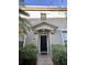Townhome's front entrance with landscaping and a black door at 6430 S Goldenrod Rd # 15B, Orlando, FL 32822