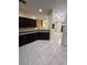 Kitchen with dark wood cabinets and tile floors at 6430 S Goldenrod Rd # 15B, Orlando, FL 32822