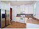 Stainless steel appliances and white cabinets highlight this kitchen at 8863 Newmarket Dr, Windermere, FL 34786