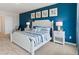 Main bedroom with a king-size bed and blue accent wall at 1034 Tupelo Trl, Haines City, FL 33844