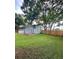 Spacious backyard with a wooden fence, green lawn, and patio area at 10483 Riva Ridge Trl, Orlando, FL 32817