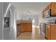 Modern kitchen featuring stainless steel appliances and light wood cabinets at 1111 Sea Eagle Ave, Groveland, FL 34736