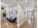 Light and bright hallway with hardwood floors and gray couch at 12550 Lakeshore Dr, Clermont, FL 34711