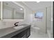 Modern bathroom with marble-look floors and dark vanity at 1511 E Horatio Ave, Maitland, FL 32751