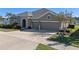 Three-car garage, stone accents, and landscaping enhance this home's curb appeal at 17092 Secret Hollow Loop, Clermont, FL 34711