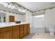 Bathroom with double vanity, soaking tub, and toilet at 172 Sheridan Ave, Longwood, FL 32750