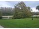 Landscaped community area with pond and trees at 2260 Cascades Blvd # 107, Kissimmee, FL 34741