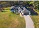 Single-story house with gray roof, paved driveway, and large yard at 41755 Viola Way, Eustis, FL 32736