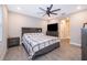 Main bedroom with ceiling fan, large bed, and ensuite bathroom access at 41755 Viola Way, Eustis, FL 32736