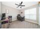 Home office with desk, chair, and ample natural light at 41755 Viola Way, Eustis, FL 32736