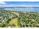 Aerial view of waterfront community with houses and a lake at 423 Eventide Ave, Mascotte, FL 34753