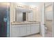 Clean bathroom with double vanity and large mirror at 4515 Cypress Cay Way, Kissimmee, FL 34746