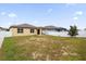 Large backyard with fire pit and partial view of a neighboring house at 535 Citrus Isle Blvd, Davenport, FL 33837