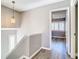 Upstairs hallway with wood-look floors and a view of a bedroom at 6021 Windhover Dr # F11, Orlando, FL 32819