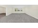Spacious bedroom with neutral carpeting and window at 8441 Chilton Dr, Orlando, FL 32836