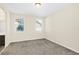 Simple carpeted bedroom with two windows and neutral walls at 8441 Chilton Dr, Orlando, FL 32836