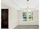 Formal dining room with chair railing and neutral colors at 8441 Chilton Dr, Orlando, FL 32836