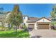 Two-story house with a two-car garage and landscaped lawn at 8441 Chilton Dr, Orlando, FL 32836