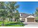 Two-story house with a large front yard and mature trees at 8441 Chilton Dr, Orlando, FL 32836