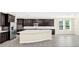 Spacious kitchen with dark cabinetry, stainless steel appliances, and an island at 8441 Chilton Dr, Orlando, FL 32836
