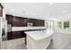 Modern kitchen with dark cabinetry and a large island at 8441 Chilton Dr, Orlando, FL 32836
