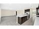 Modern kitchen with dark cabinets, stainless steel appliances and a large island at 8441 Chilton Dr, Orlando, FL 32836
