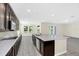 Eat-in kitchen with dark cabinetry, stainless steel appliances, and a large island at 8441 Chilton Dr, Orlando, FL 32836