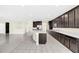 Open kitchen features dark wood cabinets, stainless steel appliances, and a large island at 8441 Chilton Dr, Orlando, FL 32836