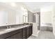 Bathroom with double vanity and walk-in shower at 8441 Chilton Dr, Orlando, FL 32836