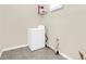 Laundry room with washer, dryer, and overhead shelving at 8441 Chilton Dr, Orlando, FL 32836
