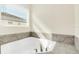 Bathroom with corner soaking tub and window at 8441 Chilton Dr, Orlando, FL 32836