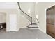 Elegant curved staircase with wrought iron railings at 8441 Chilton Dr, Orlando, FL 32836