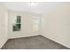 Bright bedroom with neutral walls and carpet at 8441 Chilton Dr, Orlando, FL 32836