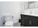 Clean bathroom with dark vanity, marble floor, and updated fixtures at 1037 S Hiawassee Rd # 2815, Orlando, FL 32835