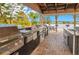 Outdoor grilling area with lake views and multiple grills at 1037 S Hiawassee Rd # 2815, Orlando, FL 32835