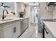 Modern kitchen with gray cabinets, quartz countertops, and stainless steel appliances at 1037 S Hiawassee Rd # 2815, Orlando, FL 32835