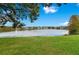 Serene lake view from across a grassy expanse at 1037 S Hiawassee Rd # 2815, Orlando, FL 32835