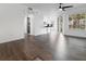 Spacious living room with wood-look flooring and access to balcony at 1037 S Hiawassee Rd # 2815, Orlando, FL 32835