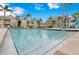 Community swimming pool with ample deck space and lounge chairs at 1037 S Hiawassee Rd # 2815, Orlando, FL 32835
