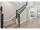 Modern staircase with dark wood railing and carpeted steps at 11968 Bracco St, Winter Garden, FL 34787