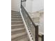 Modern staircase with dark wood railing and carpeted steps at 11968 Bracco St, Winter Garden, FL 34787