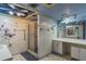 Bathroom with walk-in shower, double vanity, and decorative wall art at 1716 Sprucewood Ln, Orlando, FL 32818