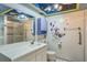 Main bathroom with shower, vanity, and decorative floral wall art at 1716 Sprucewood Ln, Orlando, FL 32818