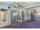 Large bedroom with mirrored closet doors and ensuite bathroom at 1716 Sprucewood Ln, Orlando, FL 32818