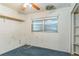 Small bedroom with blue carpet and built-in shelving at 1716 Sprucewood Ln, Orlando, FL 32818